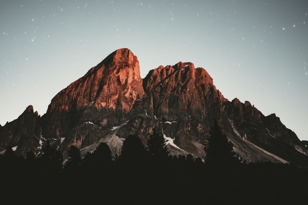 A large mountain with a sky full of stars